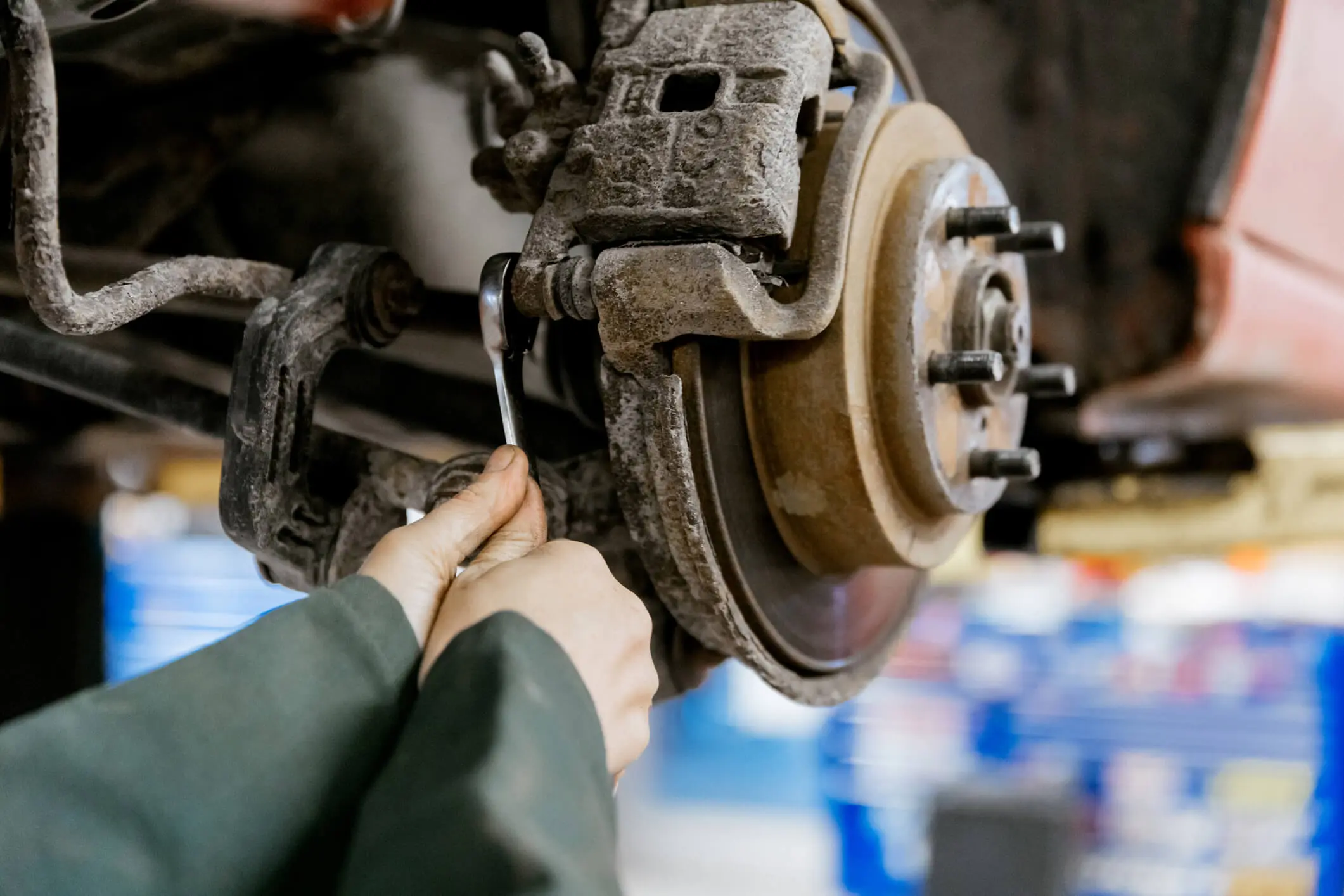 Mechanic working on car brake system.